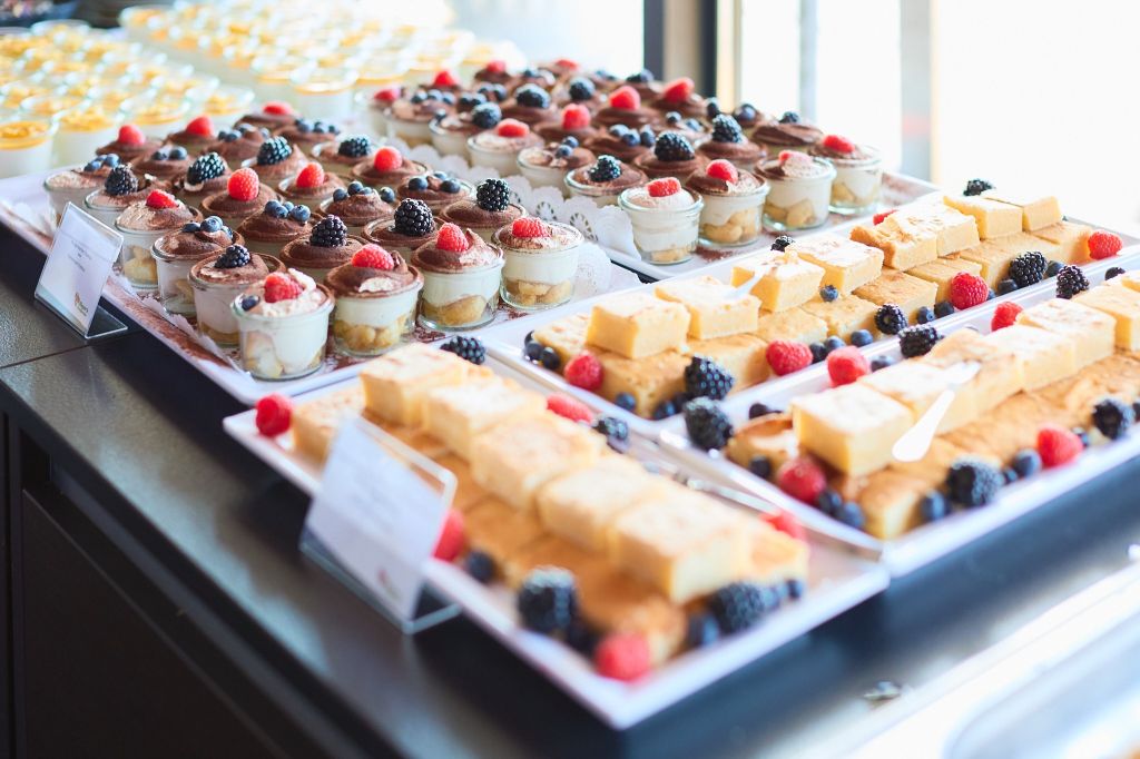 Auf dem Bild zu sehen: Das leckere Dessert auf der Jubiläumsfeier von webgo! Hausgemachtes Tiramisu in der Mitte, Kokoscreme mit Mangopürree & Minze links und rechts spanische Mandeltörtchen.